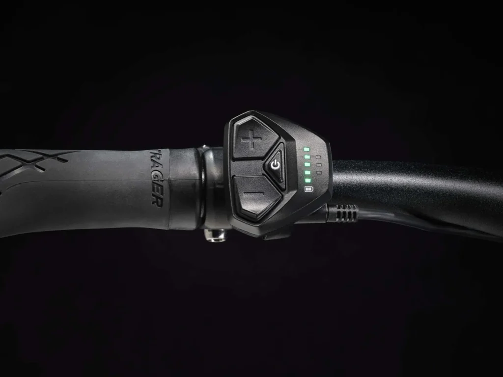 A detailed view of the Trek Dual Sport+ 2's control panel, showing the power button, battery level indicator, and mode selection buttons.