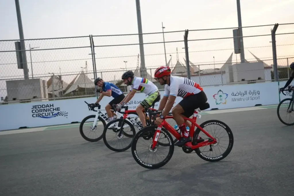 three cyclists racing in Jeddah Corniche Circuit