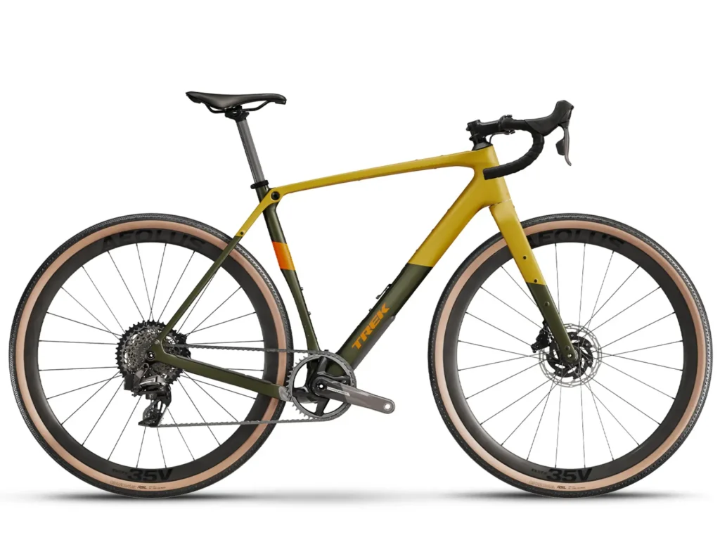 A side view of a Trek Checkpoint gravel bike in a yellow and green color scheme. It has wide tires and a carbon frame