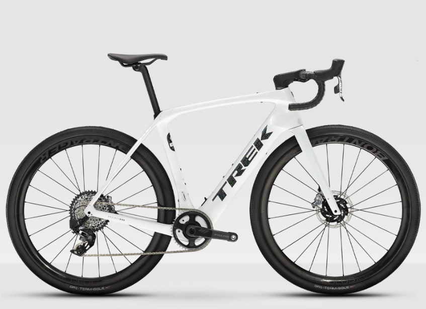 Trek Domane+ bike in a white color scheme. It has wide tires and a carbon frame