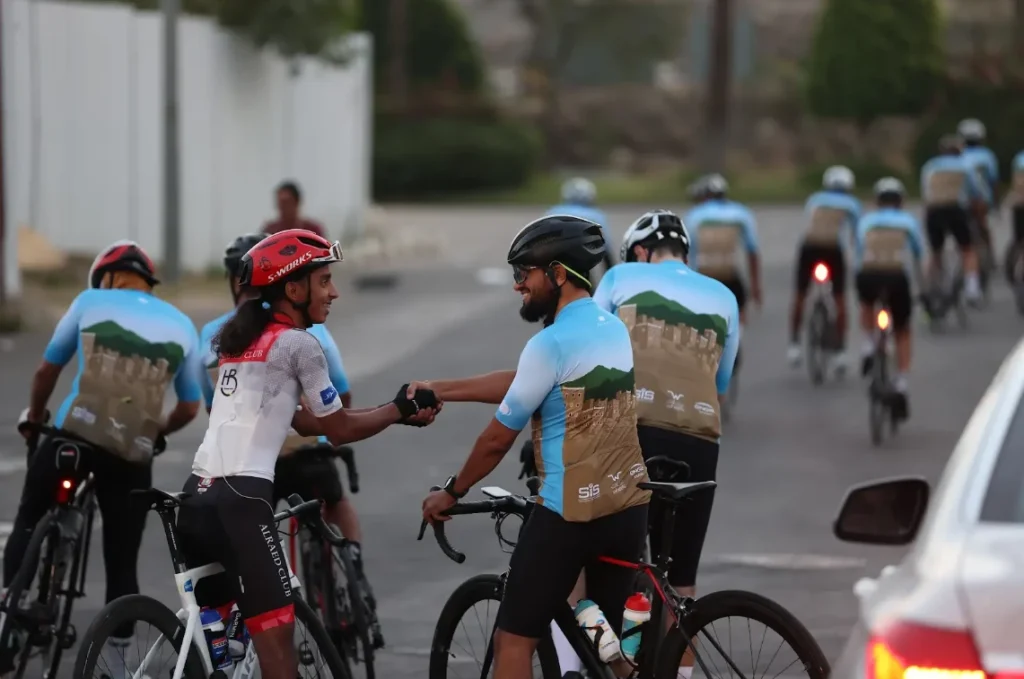 A group of cyclists takes a coffee break, relaxing and enjoying conversation